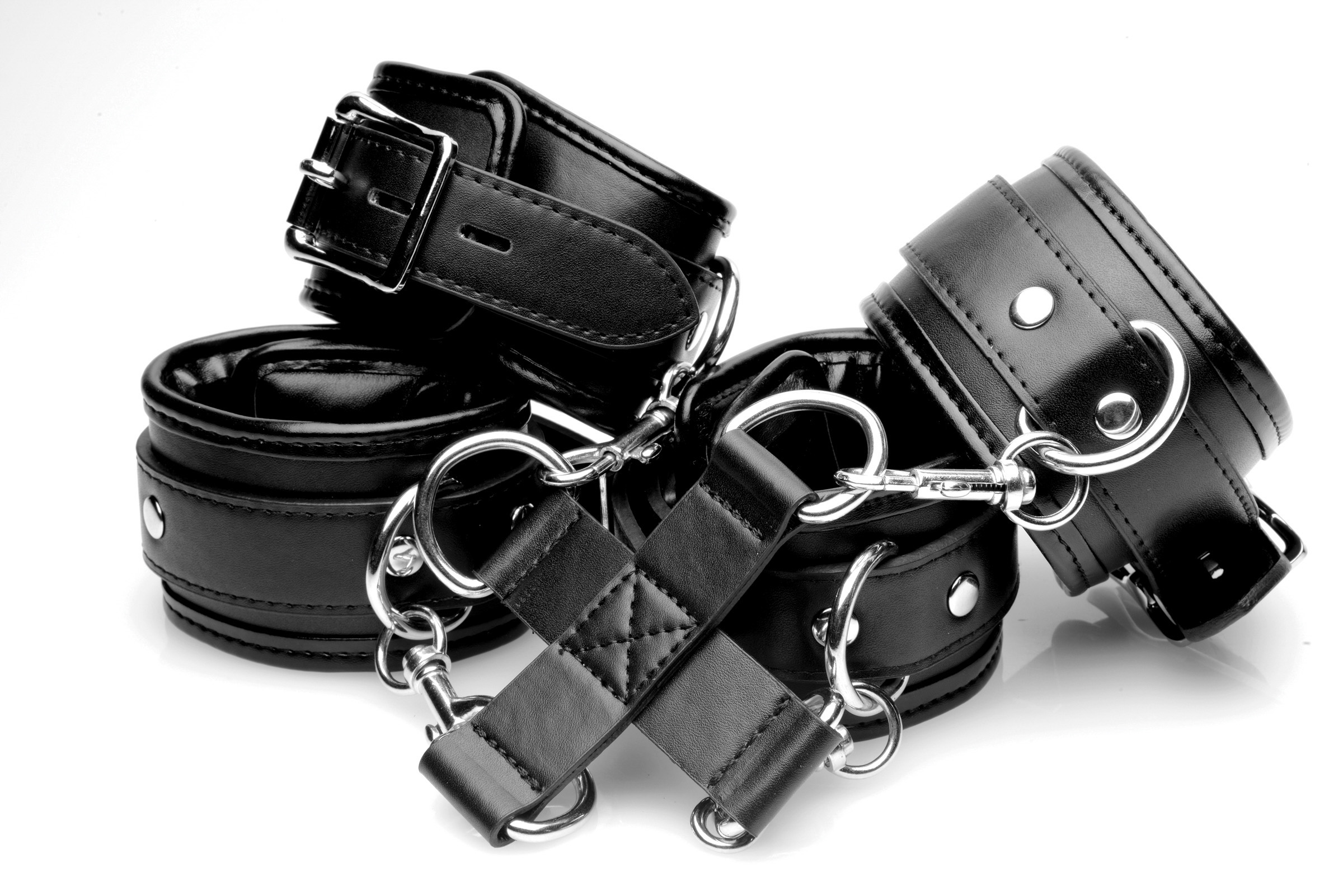 Assume the position! Put your pet into your ideal configuration of limbs with this hog-tie system! Four adjustable cuffs are lined with padding for the comfort of your submissive as you bind them up! Restrain them from the front or put them on their belly for a classic hog-tie. Locking buckles allow you to keep them confined and exposed for your pleasure! All of the cuffs are detachable and you can connect them to each other for a standard set of wrist or ankle cuffs! Make your fantasies come to life with comfort and convenience! Measurements: Wrist cuffs adjust from 2 to 8 inches in circumference. Ankle cuffs adjust from 2 to 10 inches in circumference. 2 inches in width. Center hub measures 5.25 inches in width. Material: PU Leather