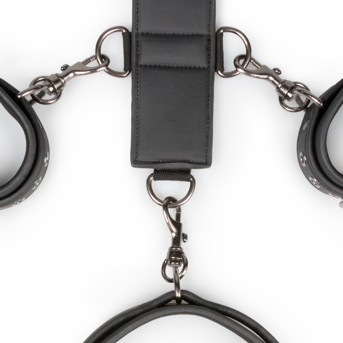 handcuffs and a collar. Both the cuffs and the collar are easily adjustable for a perfect fit. The sturdy faux leather is lined with foam to prevent scratching and to ensure a comfortable use. The bondage strap has nine small D-rings and one large D-ring. The cuffs and the collar have clip fasteners attached to them