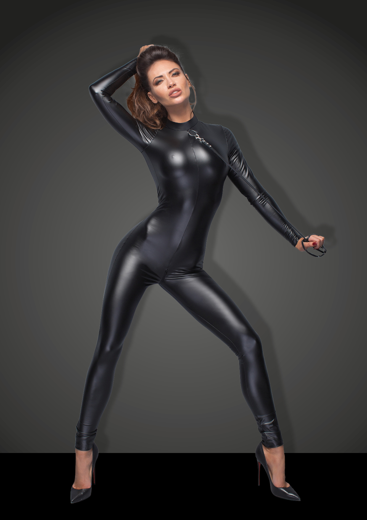 Sassy power wetlook overall with 2-way zipper in a crotch and long zipper at the back for easy access. Flashy silver ring in the collar for a naughty play. Eco-leather leash (90 cm) with decorative crystals included.