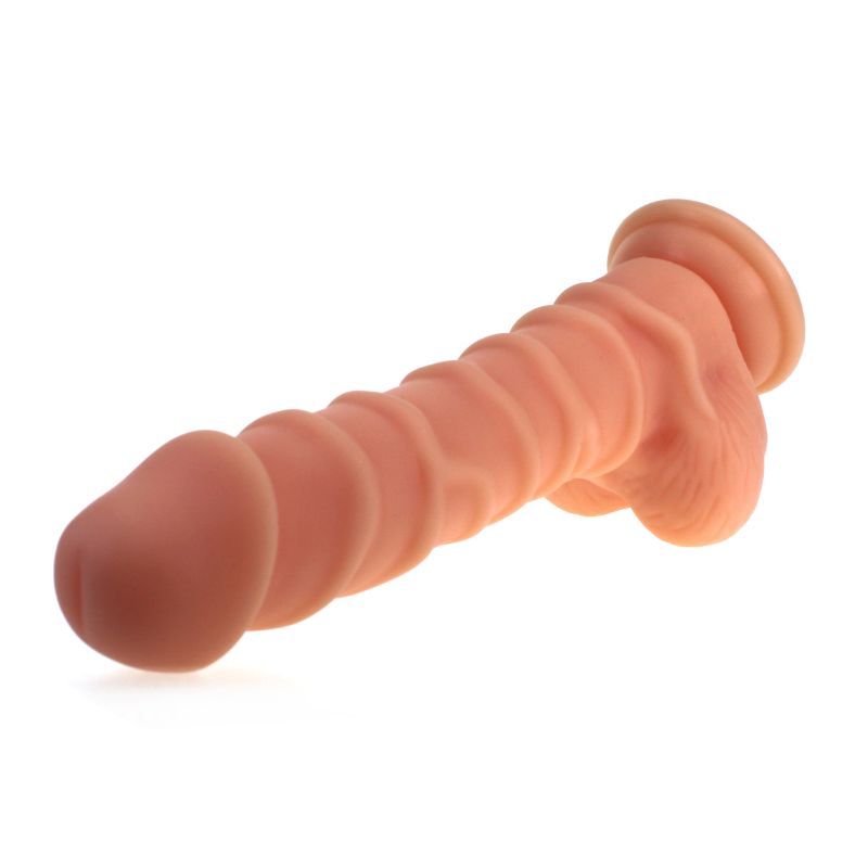 Large Penis shaped dildo with balls and ridged shaft on a suction base in flesh colour.