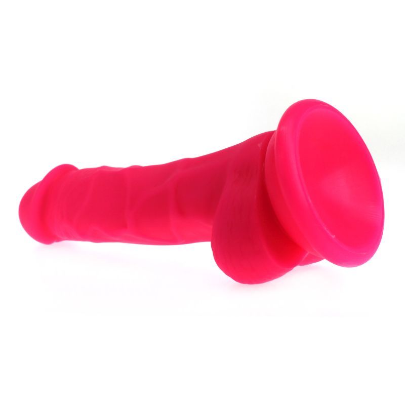Large Penis shaped dildo with balls and veined shaft on a suction base in pink colour